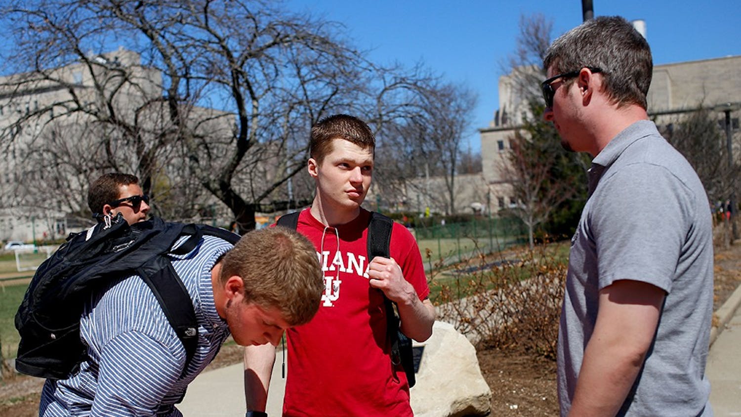 Freshman Collin Evans, left, signs up his name on the sign up sheet and senior Caleb Sperry listens about the purpose of the Empty Holster Protest from sophomore Miles Vining Wednesday right next to Wells Library. Students for Concealed on Campus at Indiana University was established in 2010 to spread awareness of the importance of freedom to carry handguns on the campus to protect themselves. The members protested by wearing a empty holster. The protest will be held until Apr.3. 