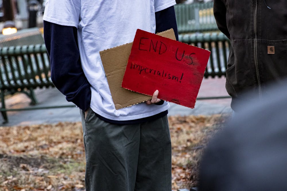 <p>A Democratic Socialists of America member holds a sign during the “No War! Rally” on Jan. 25 in People’s Park. “End U.S. imperialism,” the sign reads.</p>