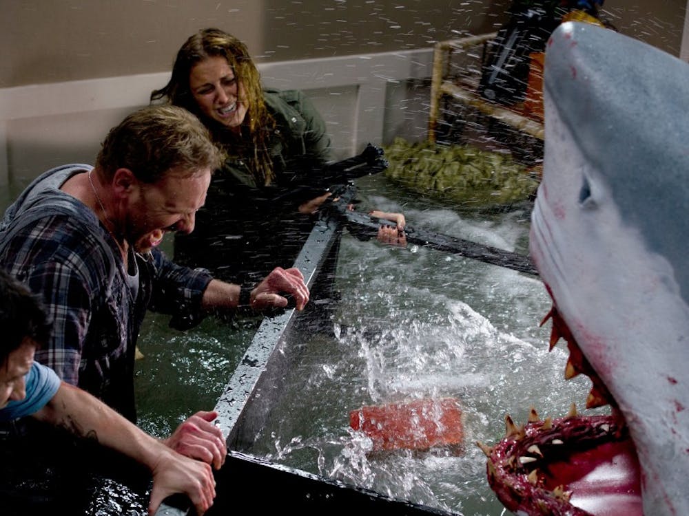 In this image released by Syfy, Ian Ziering, second left, and Cassie Scerbo battle a shark in the Syfy original film "Sharknado."  The network is announcing a sequel to "Sharknado," which became an instant campy classic with its recent airing. The new film premieres in 2014. (AP Photo/Syfy)