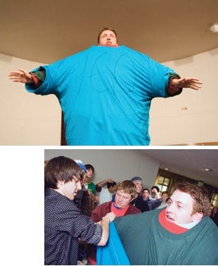 Kevin Burt, Kipp Bolin and Ryan Lettieri (left to right) bow their heads for a moment of silence at the 9-11 remembrance service Saturday at the Bloomington Township Fire Department.