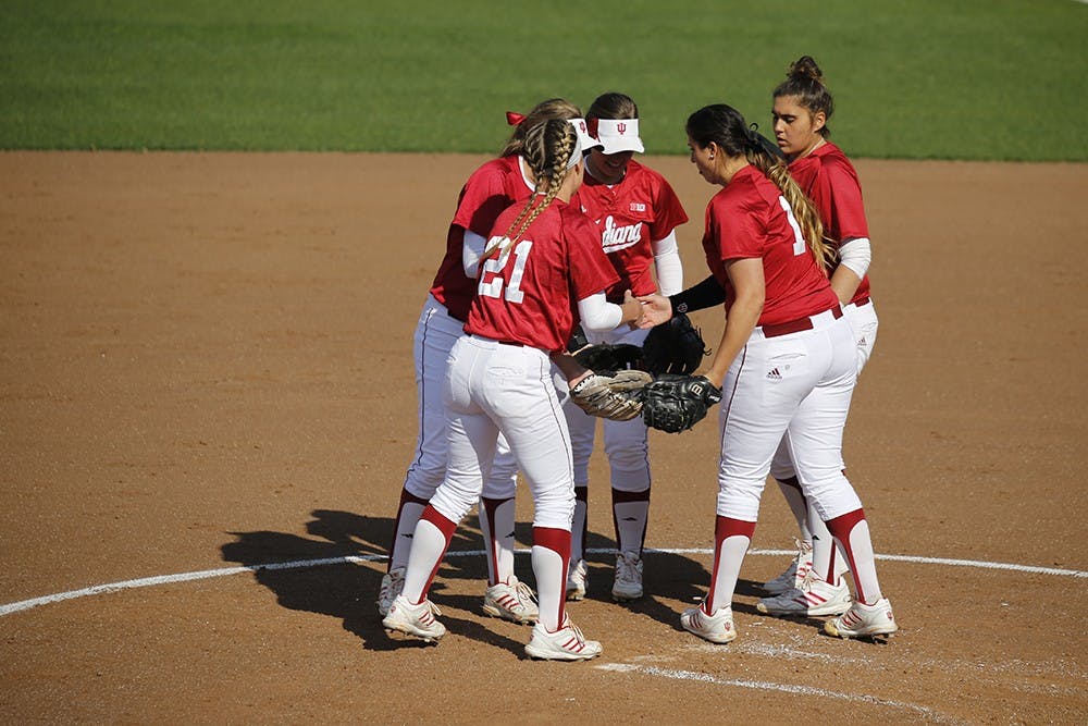 Members of the IU Softball team huddle up after Senior Pitcher Miranda Tamayo struck out an opposing player during IU's first game against Purdue Wednesday at the Andy Mohr Field. IU won 6-3 after Mena Fulton hit a 3-run home run during the last inning of the game. 