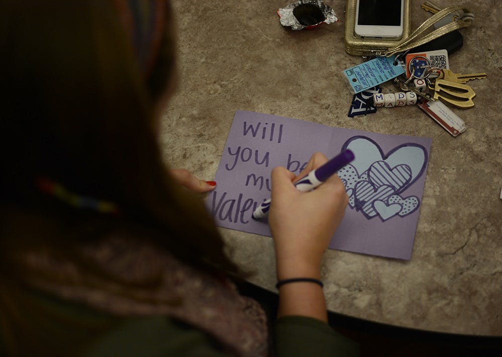 Madison Wise, junior student of IU, makes valentine cards during the event held by the college internship program and Autism Mentoring Program (AMP). Ali Matisko, student intern at AMP, said this event intent to spread awareness of autism and students with special needs.
