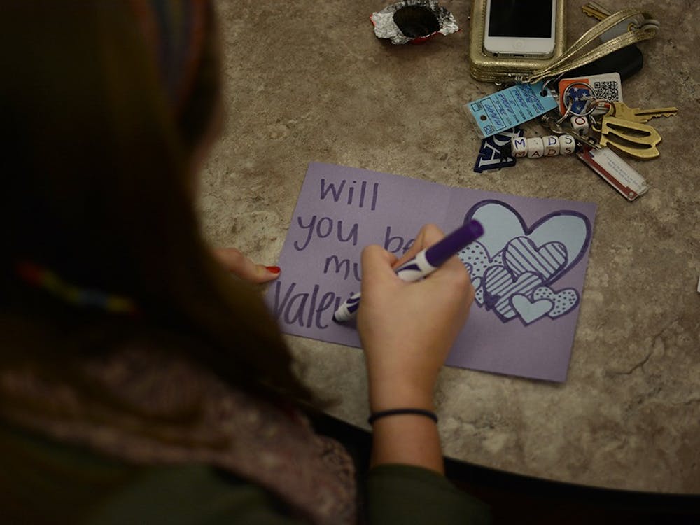 Madison Wise, junior student of IU, makes valentine cards during the event held by the college internship program and Autism Mentoring Program (AMP). Ali Matisko, student intern at AMP, said this event intent to spread awareness of autism and students with special needs.