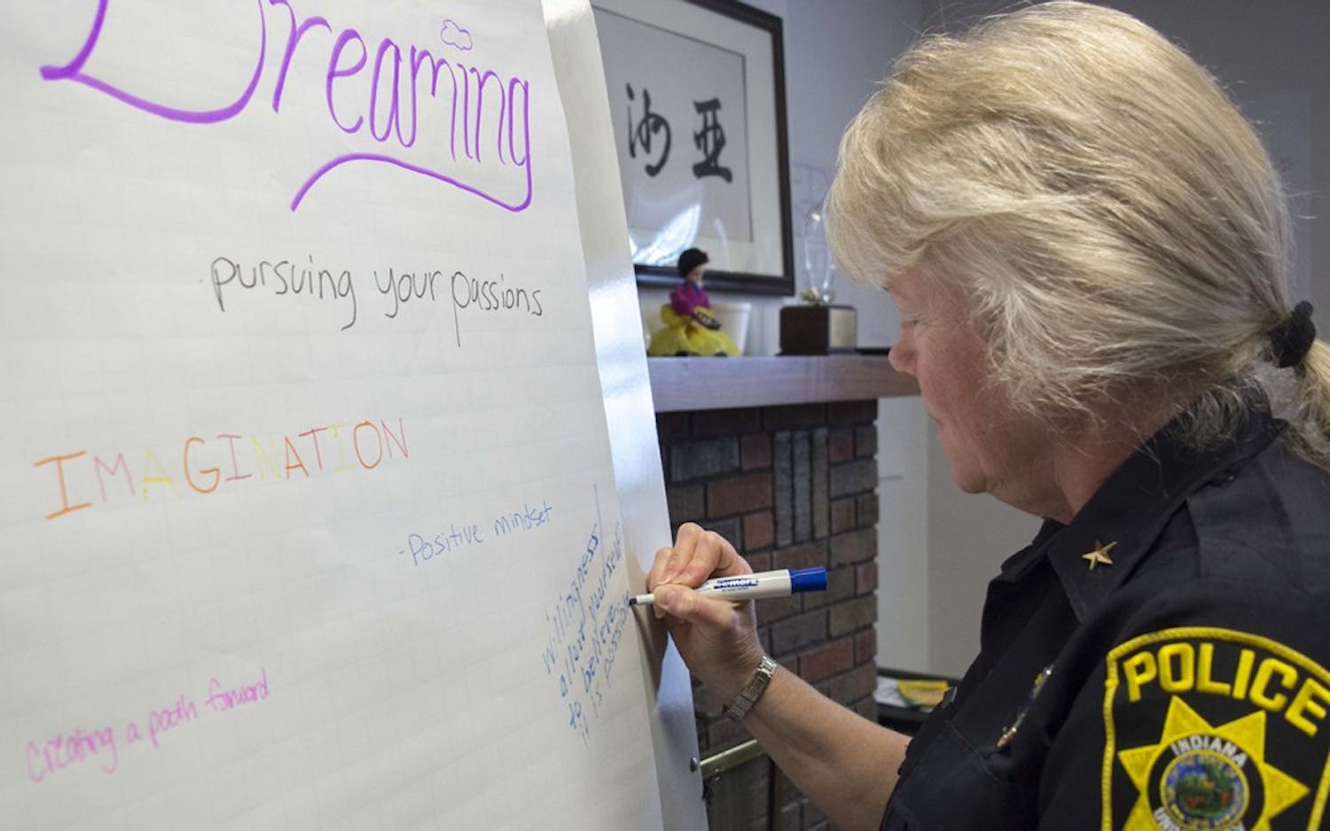 Laury Flint, Chief of Indiana University Police Department, writes donw her new year resolution during the workshop at Asian Culture Center, Jan 13. 
