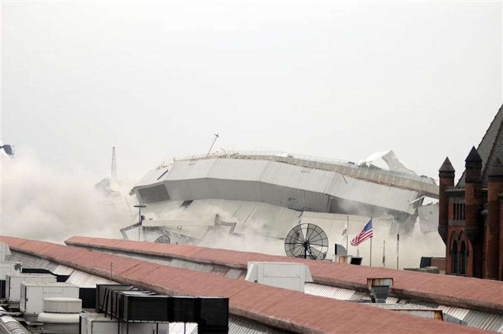 The southeast corner of the RCA Dome collapses into a heap of debris and a cloud of dust during its demolition at 9:35 a.m. Saturday morning in downtown Indianapolis.