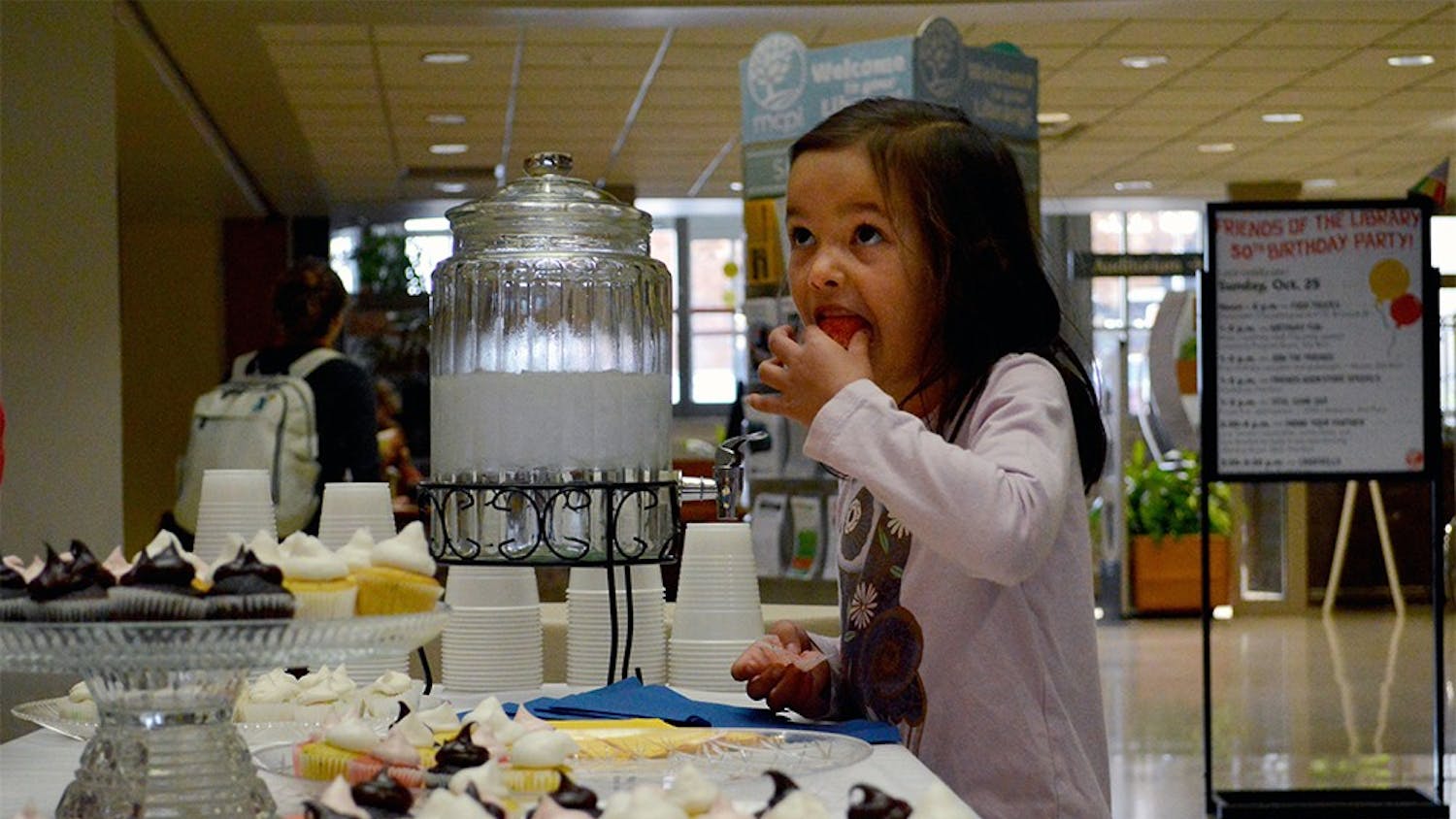Chloe Trinidad eats a free cupcake during the Monroe County Public Library's 50th birthday celebration Sunday afternoon. The library celebrated with food trucks, games, crafts and free cupcakes for their guests.