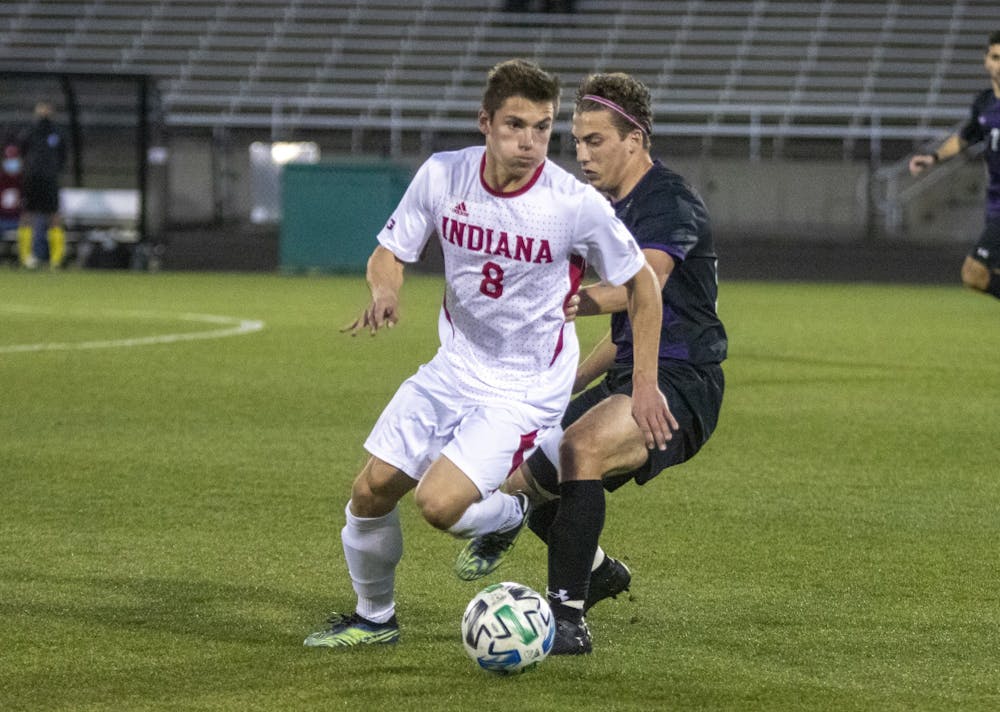 Redshirt junior Joe Schmidt passes the ball March 23, 2021, in Bill Armstrong Stadium. Indiana men's soccer will play Michigan at 5 p.m. Friday. 