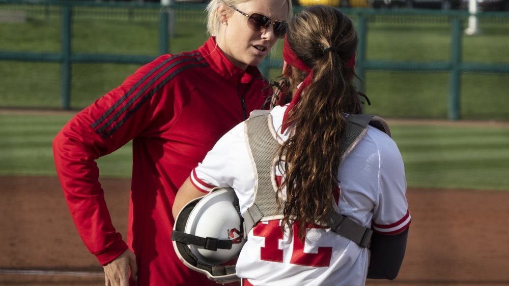 IU softball Associate Coach Chanda Bell talks to catcher Bella Norton after the third out April 10 during the first game against Purdue. IU will play Maryland on April 12-14 during a weekend series of games. 