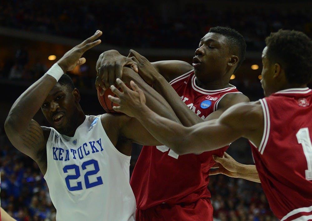 Freshman center Thomas Bryant fights for the ball with Kentucky forward Alex Poythress during the NCAA second round game against Kentucky on Saturday at the Wells Fargo Arena in Des Moines, Iowa.
