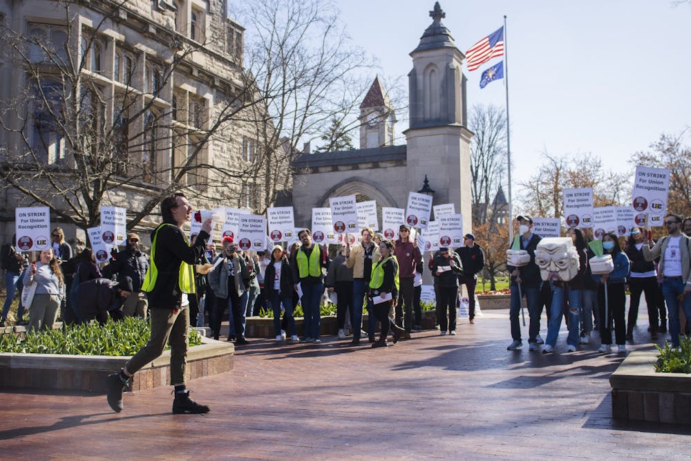 <p>Doctoral candidate Pat Wall leads a chant during the graduate student strike April 14, 2022, at the Sample Gates. The Bloomington Faculty Council voted to assert that no graduate student workers will be fired for striking in a special meeting of the council May 9.</p>