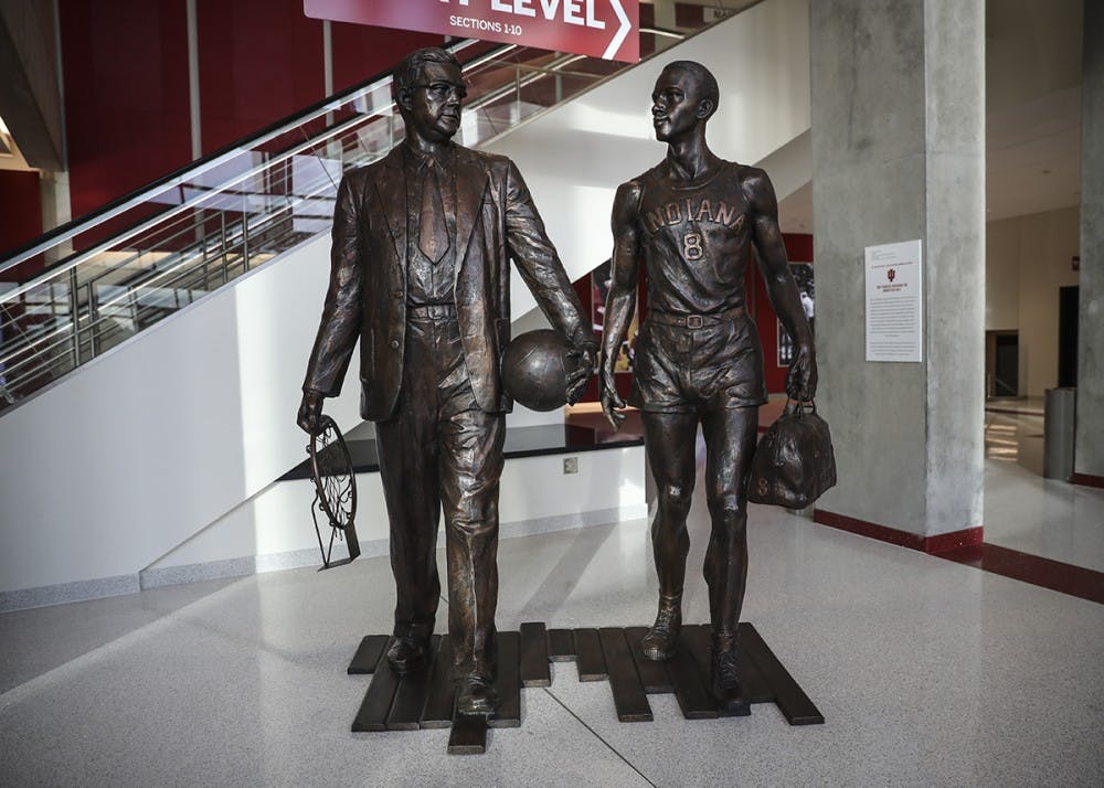 <p>Two-time national champion Branch McCracken is depicted (left) alongside Bill Garrett, who became the first African-American to play Big Ten basketball in 1948. Garrett led IU in scoring and rebounding in each of his three seasons with the team and was named an All-American in his senior season. He was coached by McCracken, a former IU player himself, who led the team to two national titles while coaching the Hoosiers.</p>