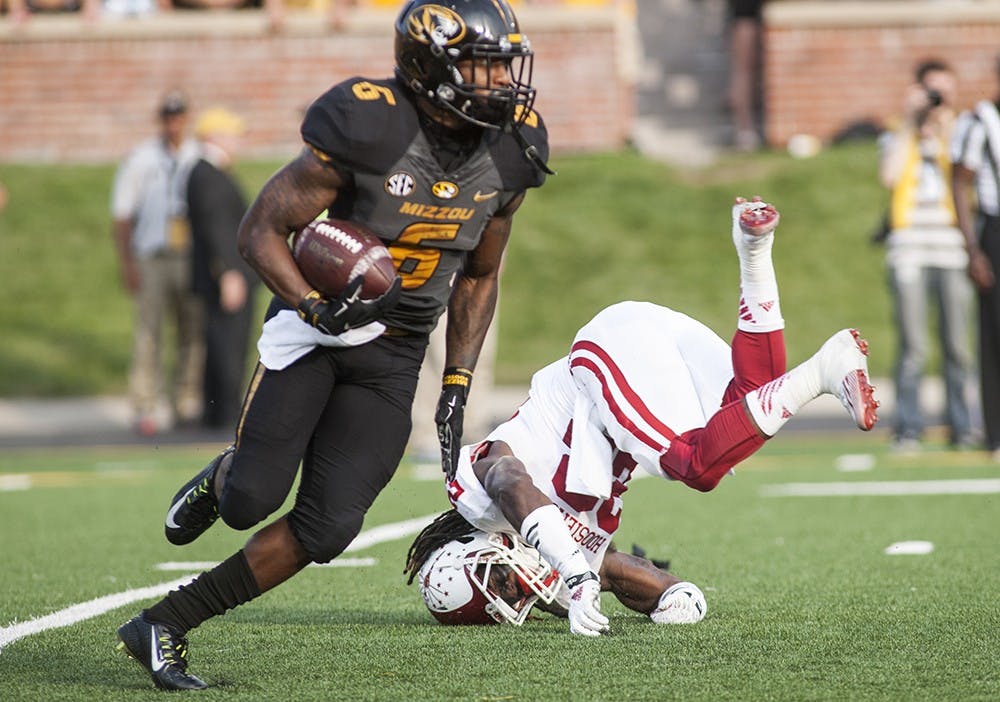 Senior cornerback Kenny Mullen falls after trying to tackle Missouri Tigers running back Marcus Murphy on Saturday at Faurot Field, in Columbia, Mo. Mullen injured his leg on the play and will be out for the remainder of the season.