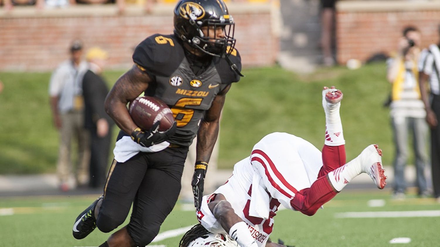 Senior cornerback Kenny Mullen falls after trying to tackle Missouri Tigers running back Marcus Murphy on Saturday at Faurot Field, in Columbia, Mo. Mullen injured his leg on the play and will be out for the remainder of the season.