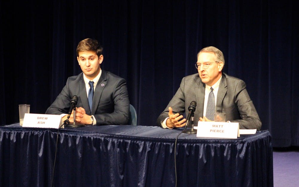 Drew Ash listens as opponent Matt Pierce responds to a question at the debate for the 61 district State Representative.