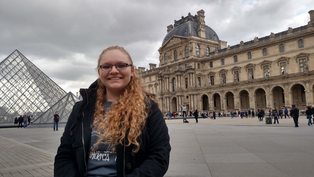 <p>Kailyn Hilycord poses for a photo near the Louvre Pyramid in Paris, France.</p>
