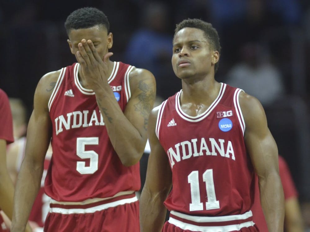  Senior guard Yogi Ferrell and junior guard Troy Williams walk back to the court after a timeout during the second half of the Sweet Sixteen game against number one seed North Carolina on . The Hoosiers lost 101-86.