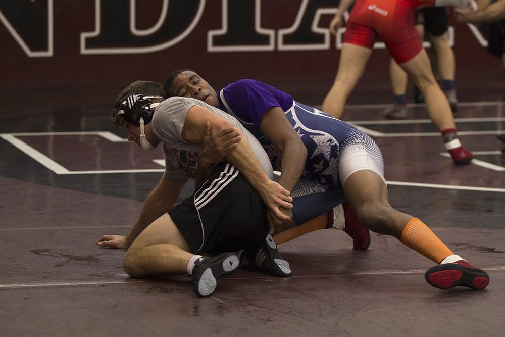 Junior Nate Jackson tries to pin a teammate during practice on Nov. 4. Jackson dominated in the first meet of the season on Saturday.