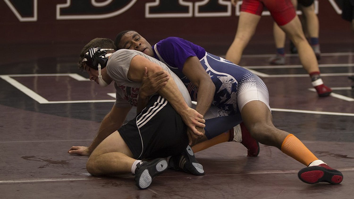 Junior Nate Jackson tries to pin a teammate during practice on Nov. 4. Jackson dominated in the first meet of the season on Saturday.