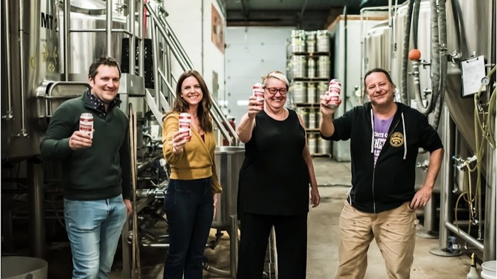 Bloomington Brewing Company&#x27;s new owners Jarrod and Amanda Franklin are pictured  toasting founders Lennie Busch and Jeff Mease after the business purchase was finalized in early January 2022. Bloomington Brewing Co. was founded in 1994. 