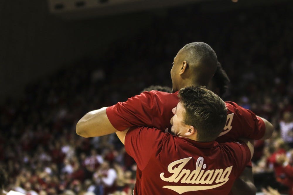 <p>Junior guard Johnny Jager lifts senior guard Quentin Taylor after IU scores against Northwestern on Dec. 1 in Simon Skjodt Assembly Hall.&nbsp;</p>
