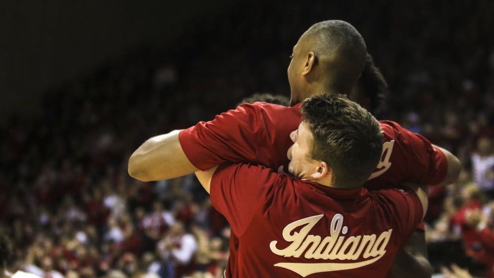 Junior guard Johnny Jager lifts senior guard Quentin Taylor after IU scores against Northwestern on Dec. 1 in Simon Skjodt Assembly Hall.&nbsp;