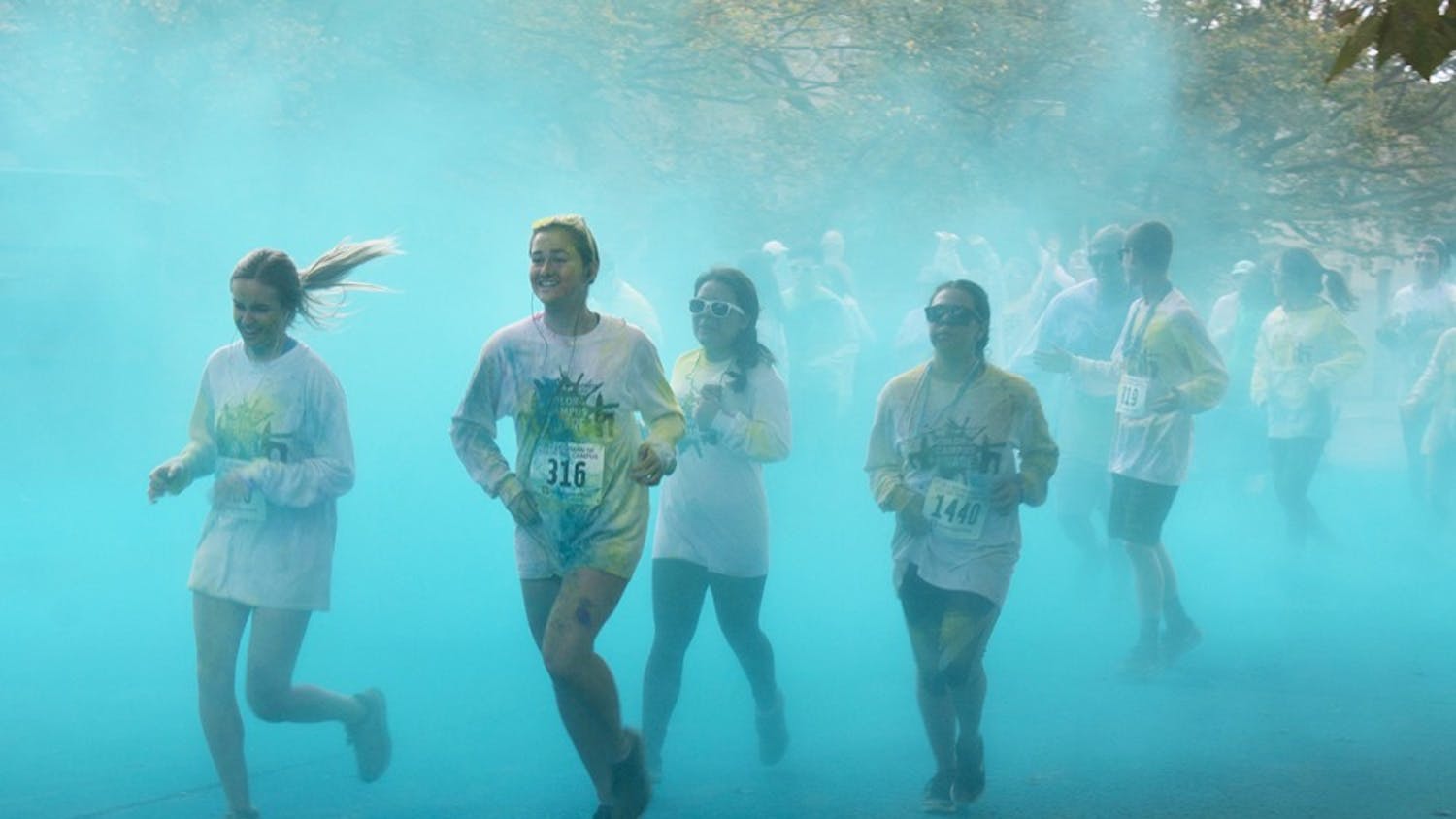 Participants run through blue powder at the last color station of the Jill Behrman Color the Campus 5K Run/Walk on Saturday. This was the 18th running of the JB5K.