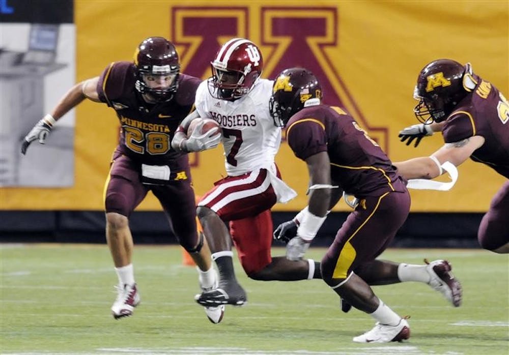 IU wide receiver Ray Fisher evades a group of Minnesota defenders during a game on Saturday in Minneapolis. Fisher had five receptions for 46 yards in IU's 16-7 loss.