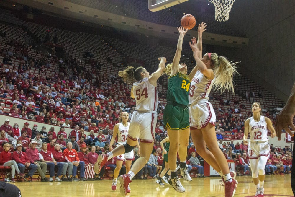 <p>Senior forward Mackenzie Holmes and junior guard Sydney Parrish attempt to block a shot during the game against University of Vermont Nov. 8, 2022, at Simon Skjodt Assembly Hall. Holmes scored 17 points during the game against UMass Lowell.</p>