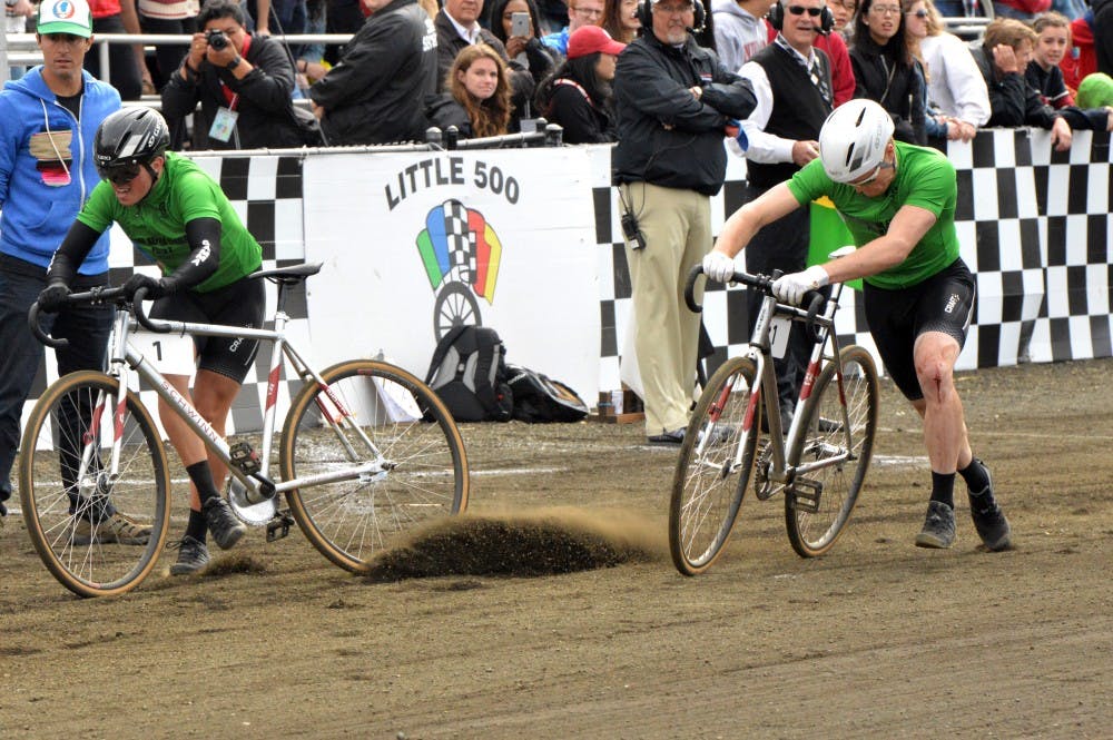 <p>Sigma Alpha Epsilon exchanges bikes at the Men's Little 500 in 2017 at Bill Armstrong Stadium. Dirt from the track gets moved by the tire of one of the bikes, because of the dry track. Cyclists may prefer the track to be more wet for an easier and faster ride on the track. &nbsp;</p>