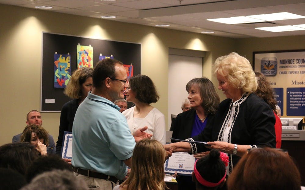 Board members give the YesforMCCSC campaign volunteers a standing ovation at Tuesday night's board meeting.
