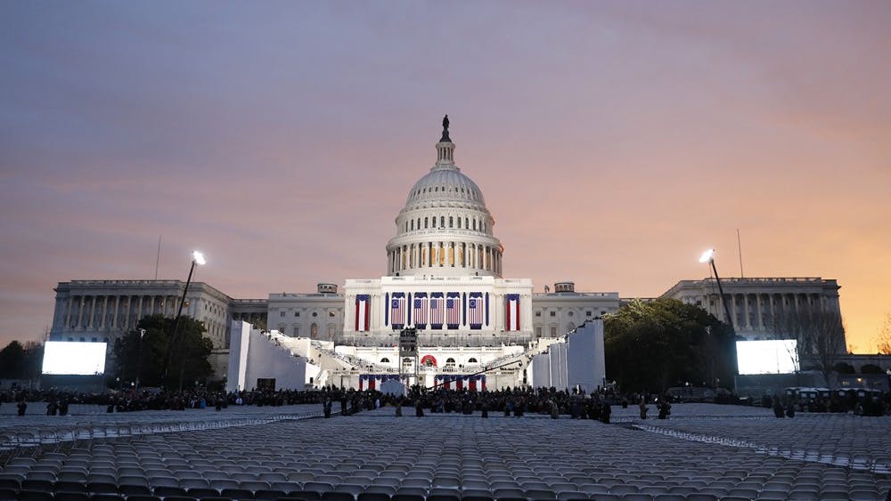 The sun rises over the United States Capitol Building.
