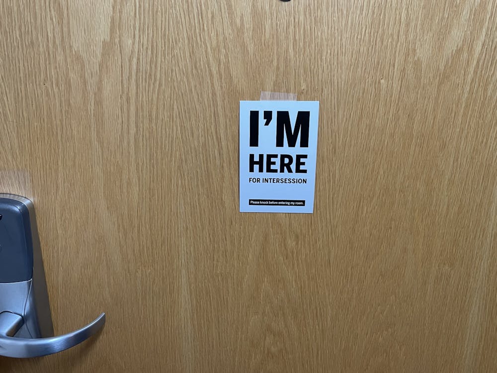 <p>An &quot;‘I’m Here’&quot; card hangs on a door on Nov. 15, 2021, at a dorm room in Wilkie Quad. Students staying on campus for Thanksgiving should tape signs to their doors to alert maintenance that they are inside.</p>