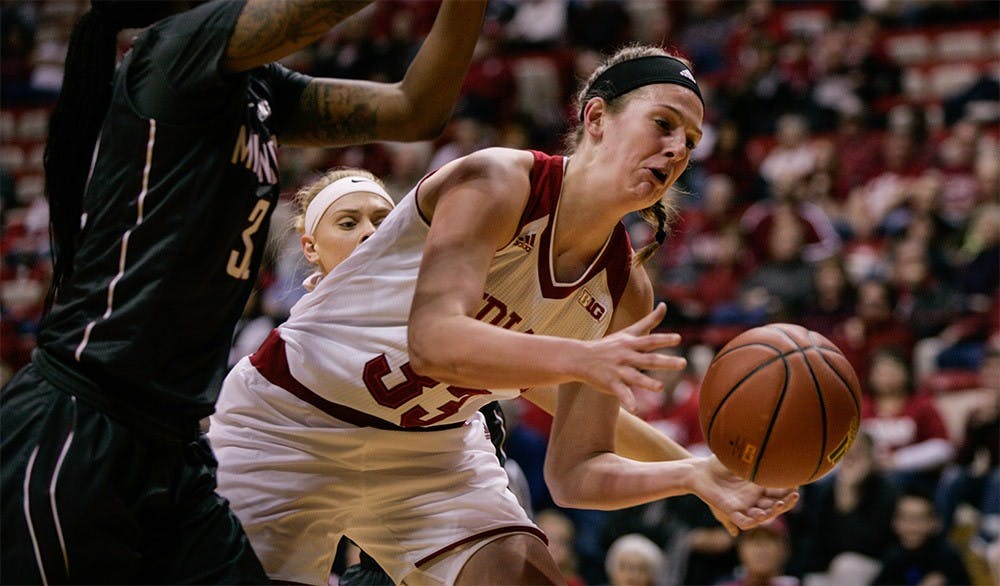 Sophomore forward Amanda Cahill reaches for the ball before it goes out of bounds. IU defeated Minnesota 93-79 Feb. 18.