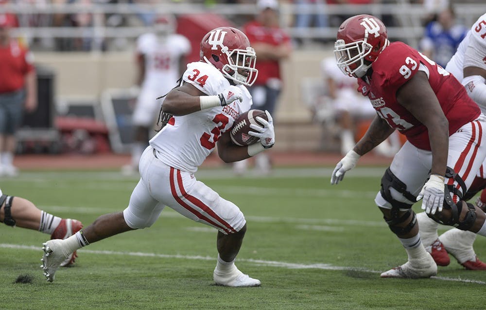 Sophomore running back Devine Redding runs with the ball during IU's spring game Saturday at Memorial Stadium.
