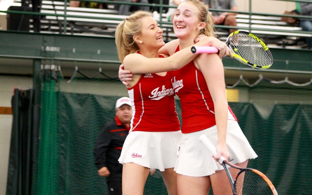 Sophomore Madison Appel hugs partner, senior,&nbsp;Kim Schmider after winning a close match in doubles against Notre Dame.&nbsp;