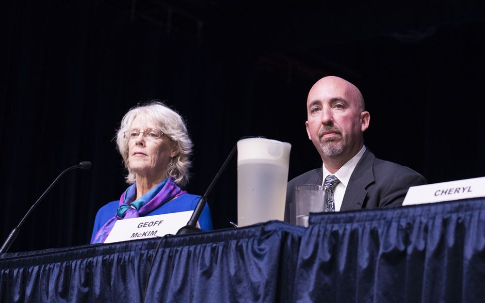 Elizabeth "Lee" Jones and Geoff McKim give their opening statements at the county council debate at the Monroe County Public Library Wednesday night.