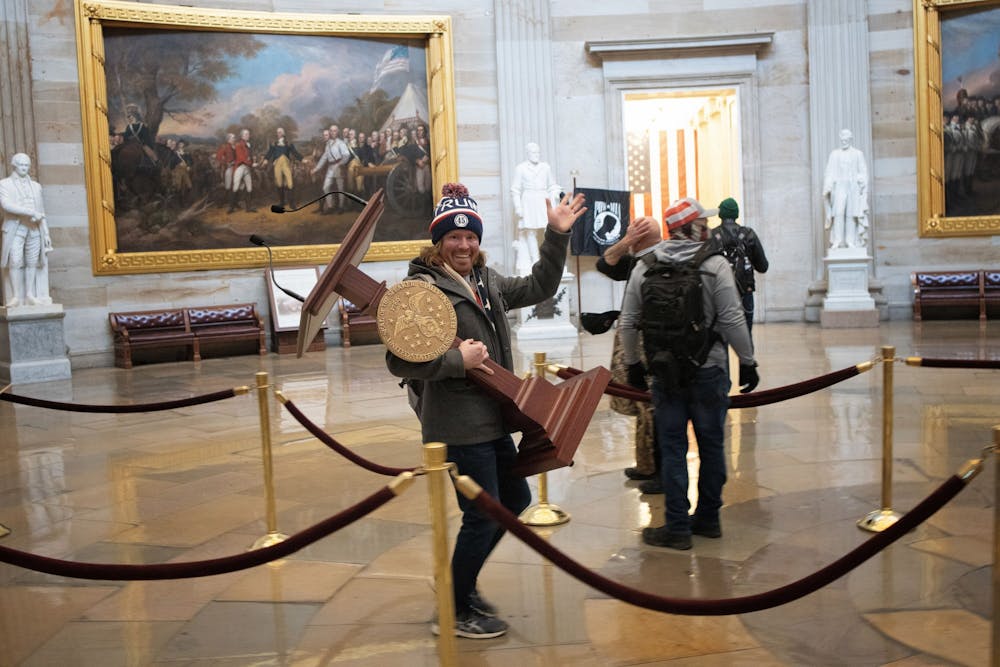 <p>A Trump supporter carries the lectern of U.S. Speaker of the House Nancy Pelosi through the Rotunda of the U.S. Capitol Building after a pro-Trump mob stormed the building on Jan. 6, 2021, in Washington, D.C. Though it has been a year since the insurrection at the Capitol, little has changed since.</p>