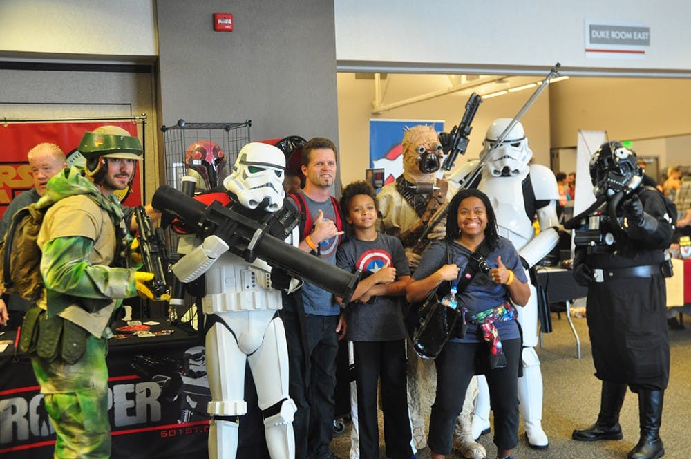 Visitors take photos with cosplayers potraying  Star Wars characters at the Indiana Toy and Comic Expo that took place at the Monroe County Covention Center Sunday afternoon. 