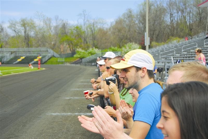 Sean Morrison | IDS
Junior Adam Bailey, a rider for Vicious & Delicious who cannot ride this year, cheers on his team as they sprint for their bikes during Team Pursuit on April 18. Bailey suffered a brain hemorrhage and skull fracture after falling off a bike while delivering sandwiches for Jimmy John’s, where the team members work.