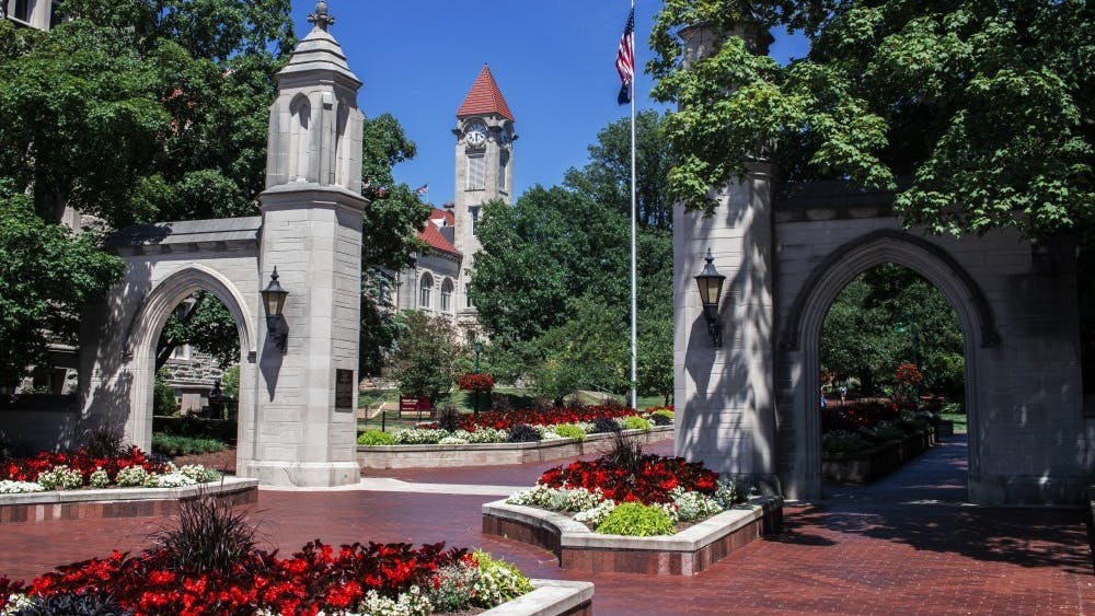 Sunshine illuminates the Sample Gates on June 28, 2019, on the IU-Bloomington campus. Some professors have voiced their concerns over the university&#x27;s reopening.