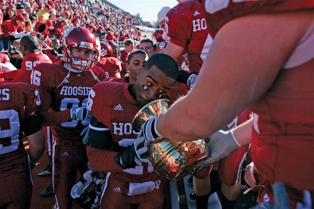 <p>Then-sophomore safety Brandon Mosley prepares to spit into the Old Brass Spittoon after Indiana&#x27;s 46-21 victory against Michigan State on Oct. 28, 2006, in Memorial Stadium.﻿ The Hoosiers defeated the Spartans 39-31 on Saturday in East Lansing.</p>