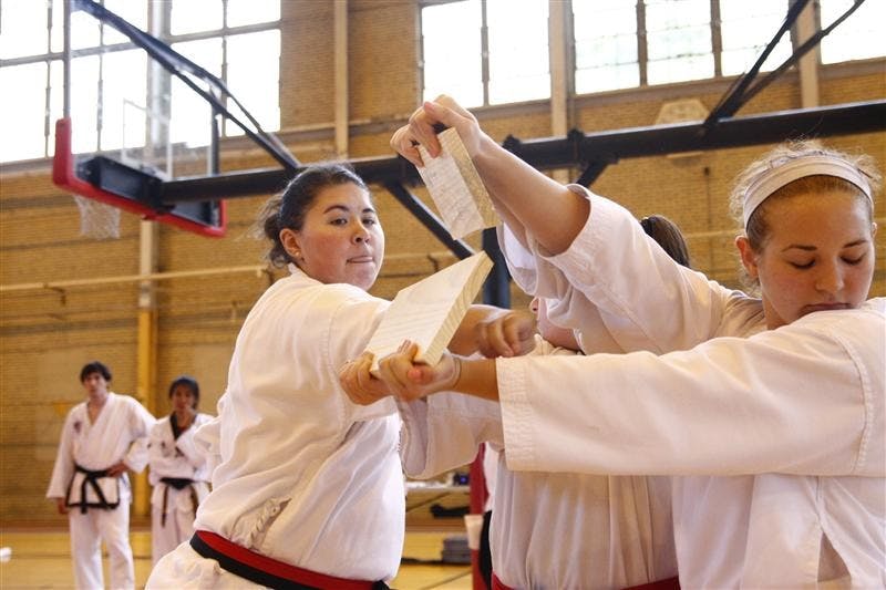 IU junior Abby Housenstein breaks a board Saturday afternoon at the Ora L. Wildermuth Intramural Center.