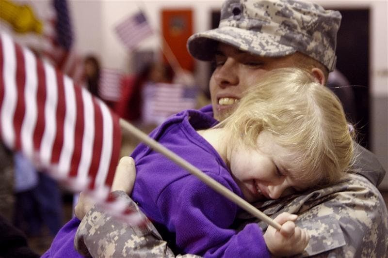Specialist Chad Ray, of Lyons, Ind., embraces his daughter Harley, age two as he returns from 11 months of service in Iraq on Monday at the National Guard Armory on South Walnut Avenue. Ray had been gone since Jan. 2.