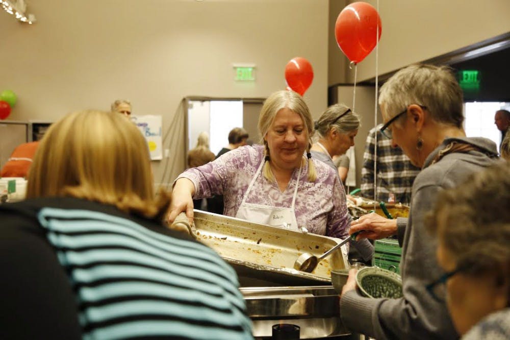 <p>Robin Menzyka, a volunteer at the 24th Annual Soup Bowl Benefit, serves soup for attendees Sunday, Feb. 18. The soup bowl is a fundraising opportunity for Hoosier Hills Food Bank that served soup from 42 local business this year.&nbsp;</p>