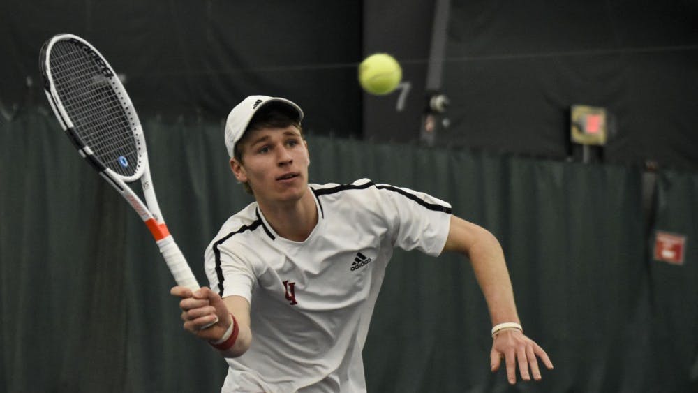Then-sophomore Bennett Crane reaches for a forehand during his 6-2, 6-7, 4-6 singles loss against Wisconsin last season at the IU Tennis Center. 