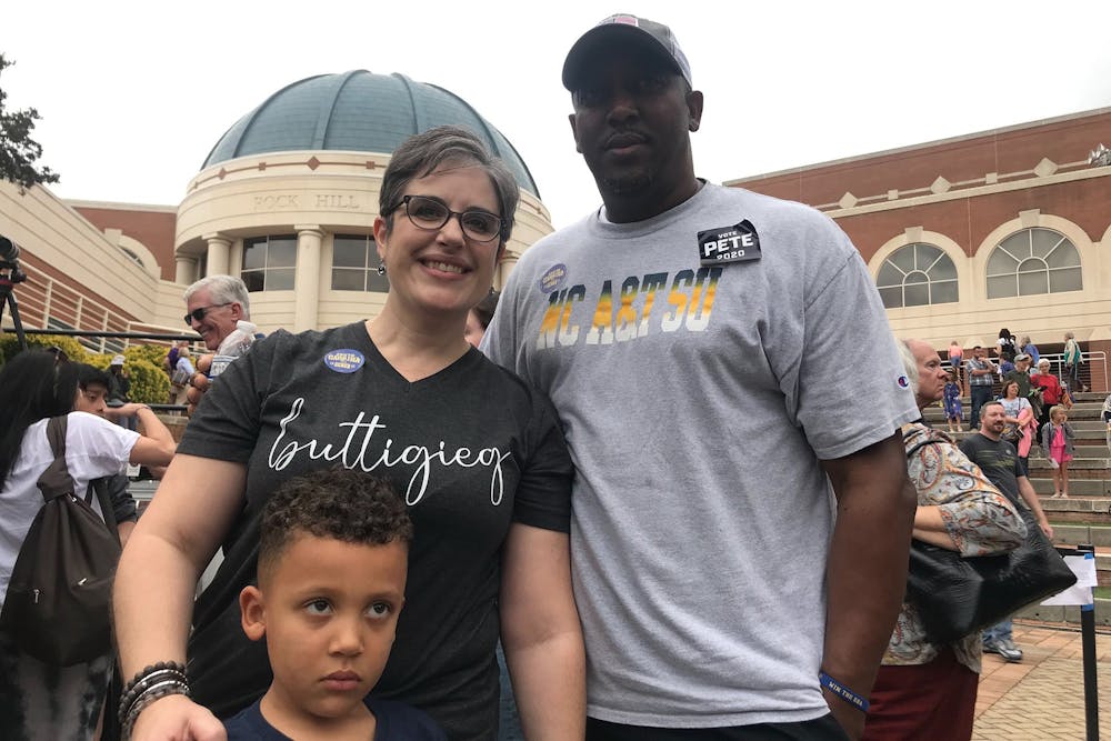<p>Orange County resident Lauren Williams stands with her family Oct. 26 as a Pete Buttigieg supporter. Her husband, Lamont, leans toward former Vice President Joe Biden, but wore a &quot;Pete 2020&quot; for his wife. </p>
