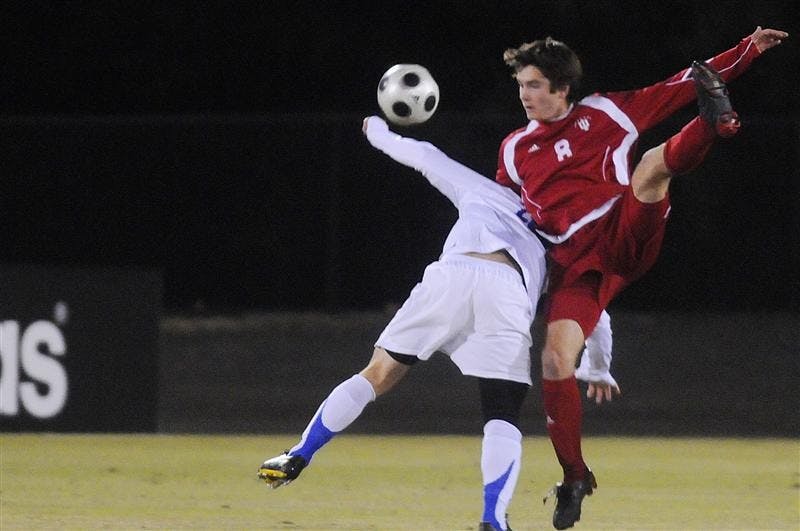 IU senior midfielder John Mellencamp heads a ball over a Kentucky defender during a game on Oct. 29 at Bill Armstrong Stadium. IU tied Kentucky 1-1.