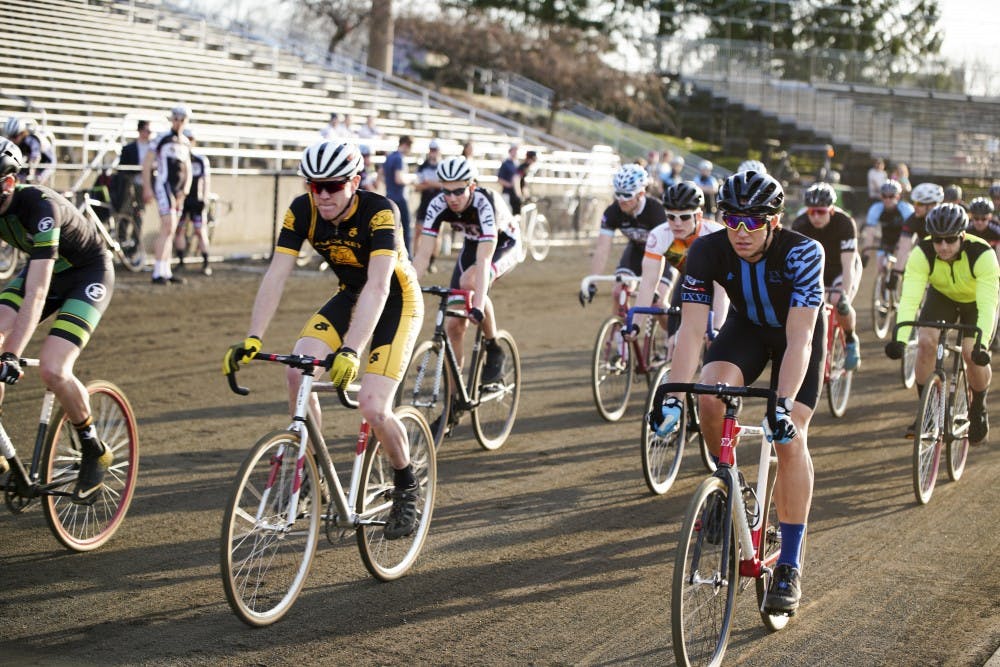 <p>Participants race around the track to complete 50 laps during a practice session for Little 500 on Thursday evening at Bill Armstrong Stadium.</p>