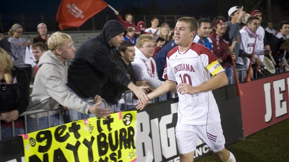 Senior midfielder Andy Adlard celebrates with students in "The Cage," IU's student section, after winning the Big Ten Championship on Oct. 31 at Bill Armstrong Stadium.
