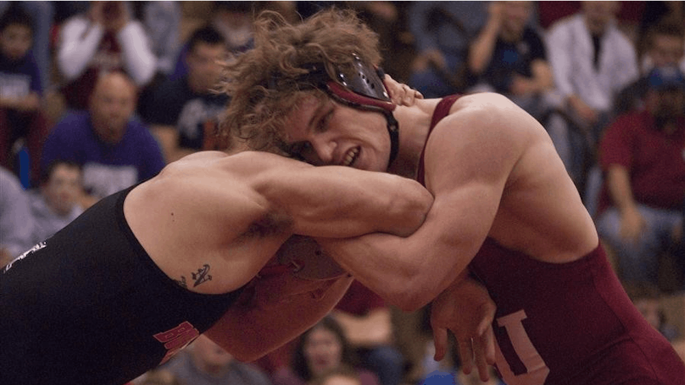 IU junior and 157-pound grappler Kurt Kinser locks up with Sean Nemec of Ohio State during Sunday's dual meet at University Gym in Bloomington. While Kinser won, bringing his Big Ten record to 4-0, the No. 14 Hoosiers lost to the No. 4 Buckeyes by a score of 22-13.